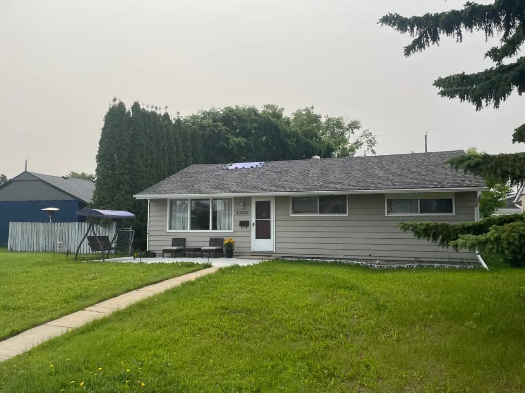 Northwest Edmonton roof with a wind-damaged shingle section