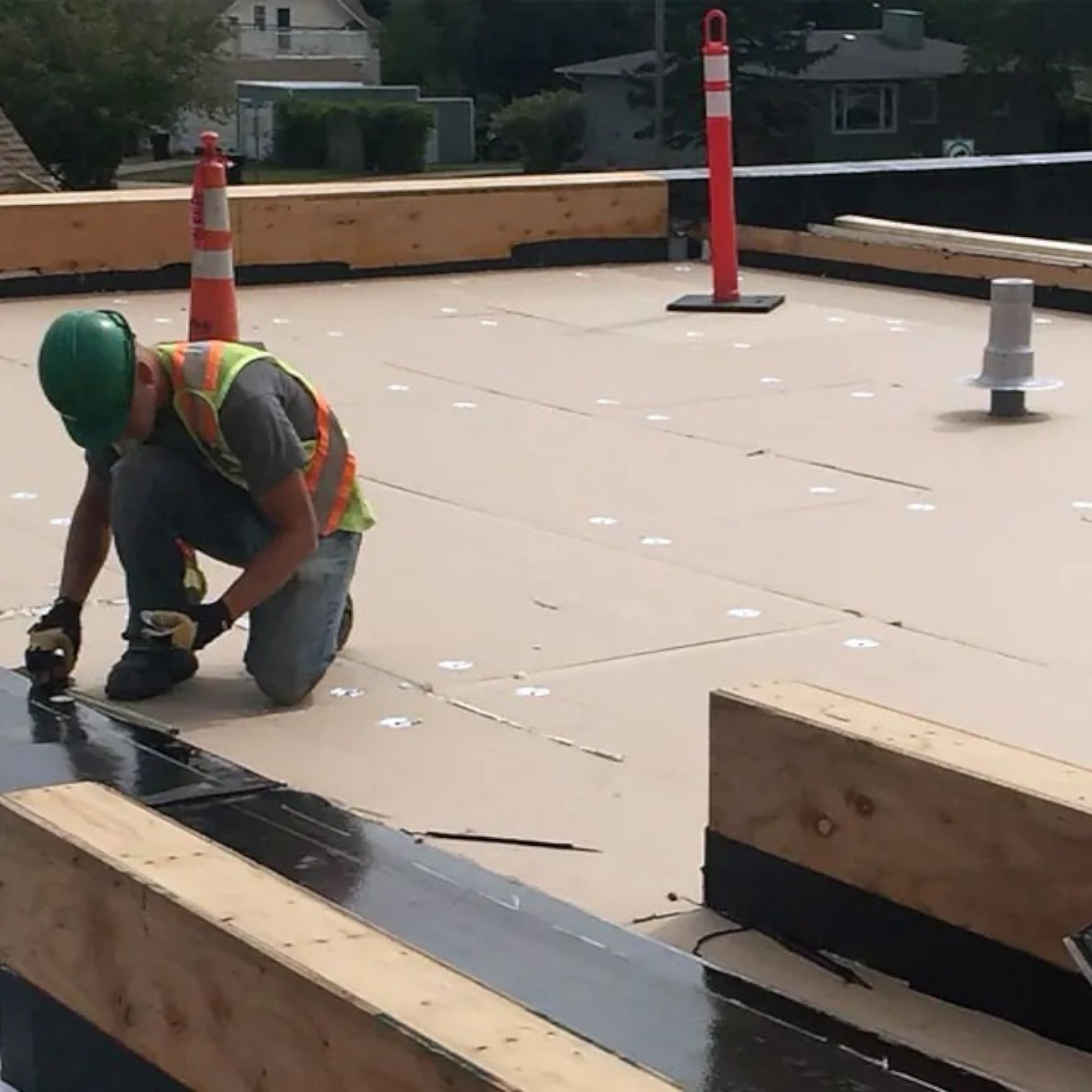 Roofing contractor performing a commercial flat roof repair on an Edmonton property